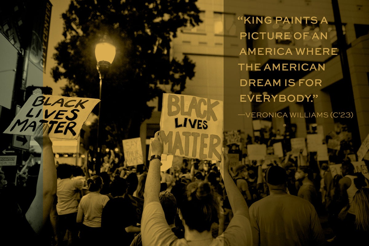 people holding signs that say "black lives matter"